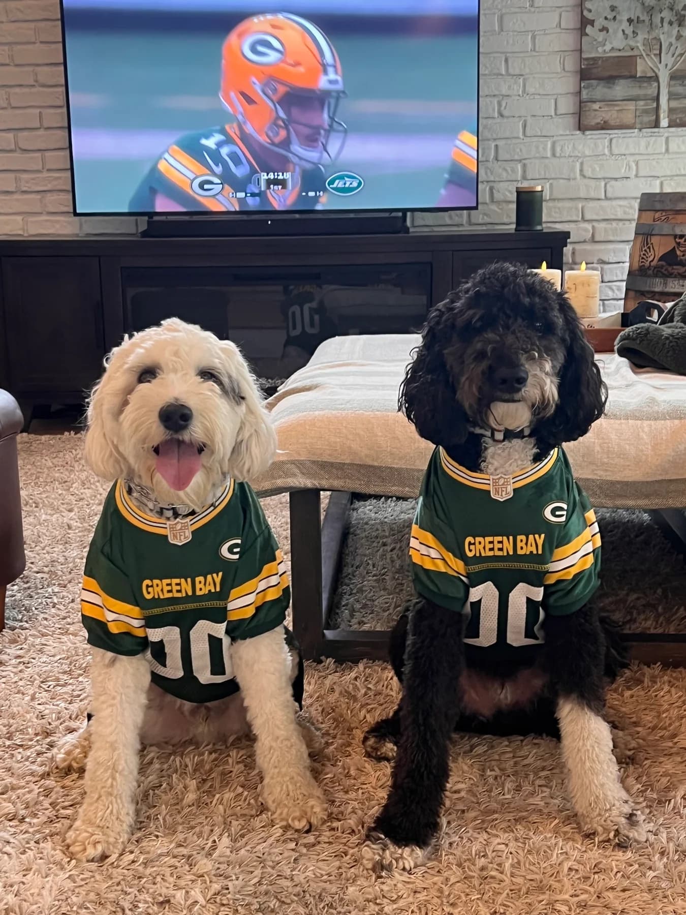 Will and Frank wearing green football jerseys indoors