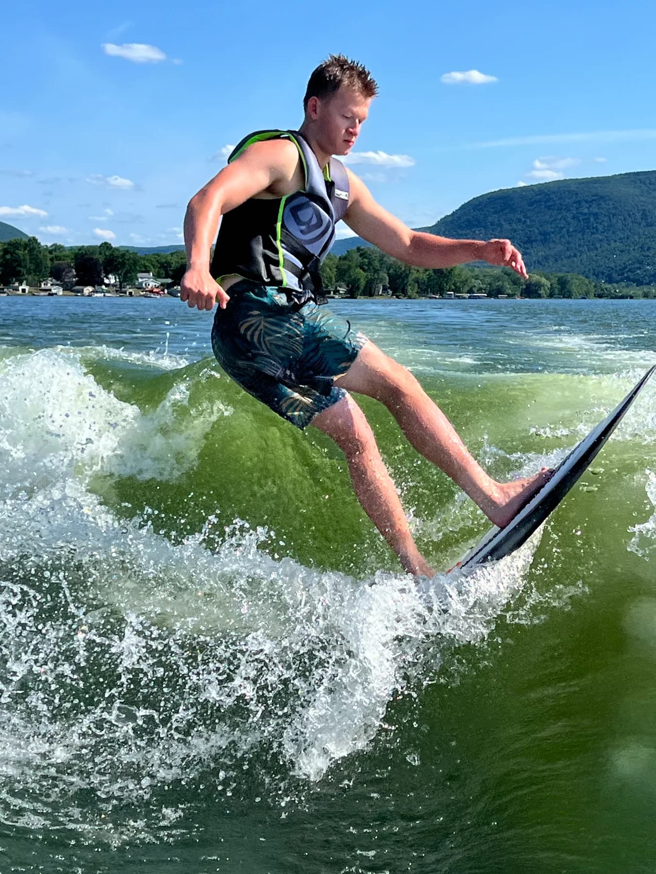 Person wake surfing across a lake